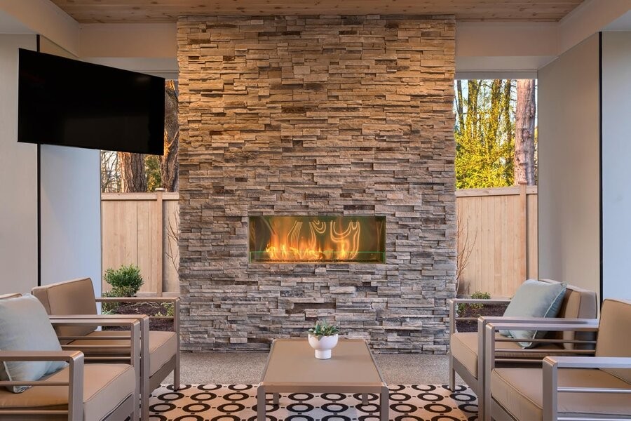 A living space with a media setup featuring a mounted TV over a fireplace.