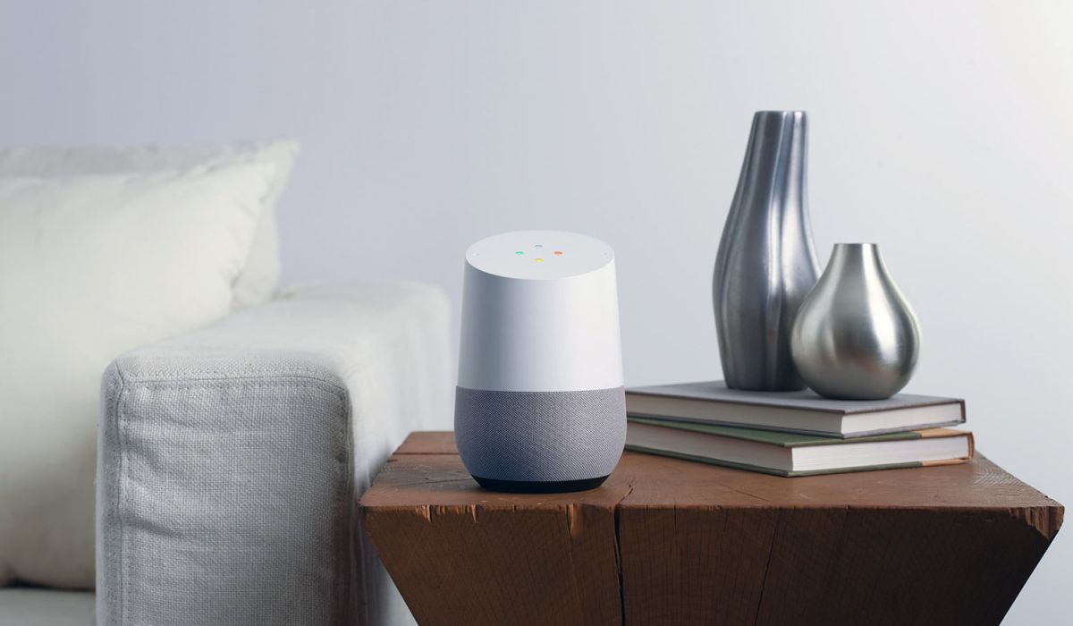google speaker on side table next to white couch