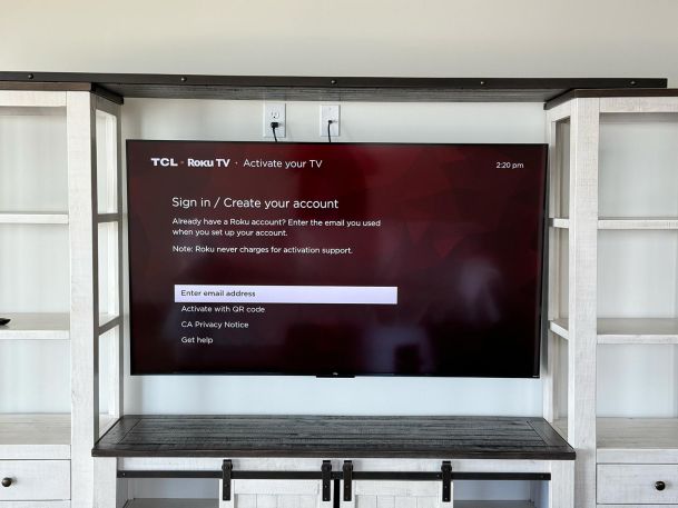 Television screen showing a setup menu with shelving units on either side.